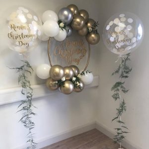 christening confetti bubble balloons with fern tail and balloon hoop cluster