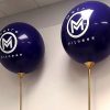 purple giant balloon with white text and mounted on gold pole close