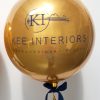gold orbz balloon with navy text