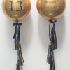 gold orbz balloon with navy tassel