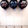 three gender reveal balloons in a row